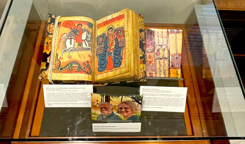 Exhibit curators posing with poster.