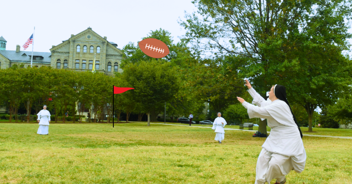 Three nuns play football in a field of green grass. 