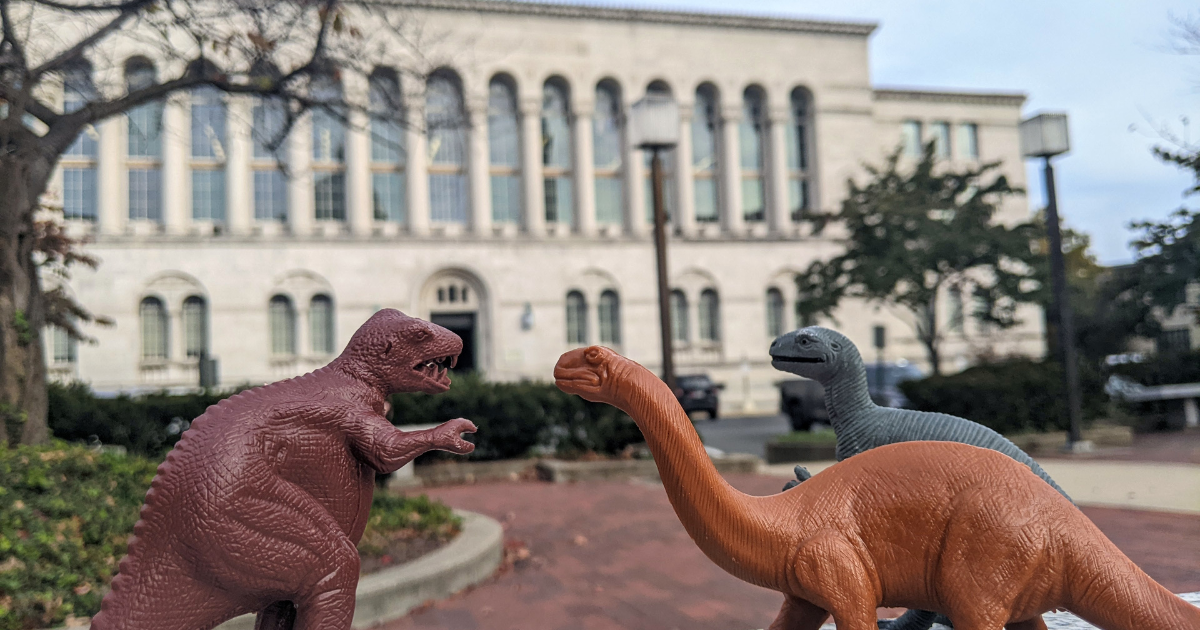 toy dinosaurs in front of Mullen Library